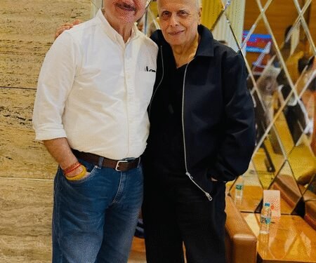 Anupam Kher poses with Mahesh Bhatt as the two bump into each other at the airport